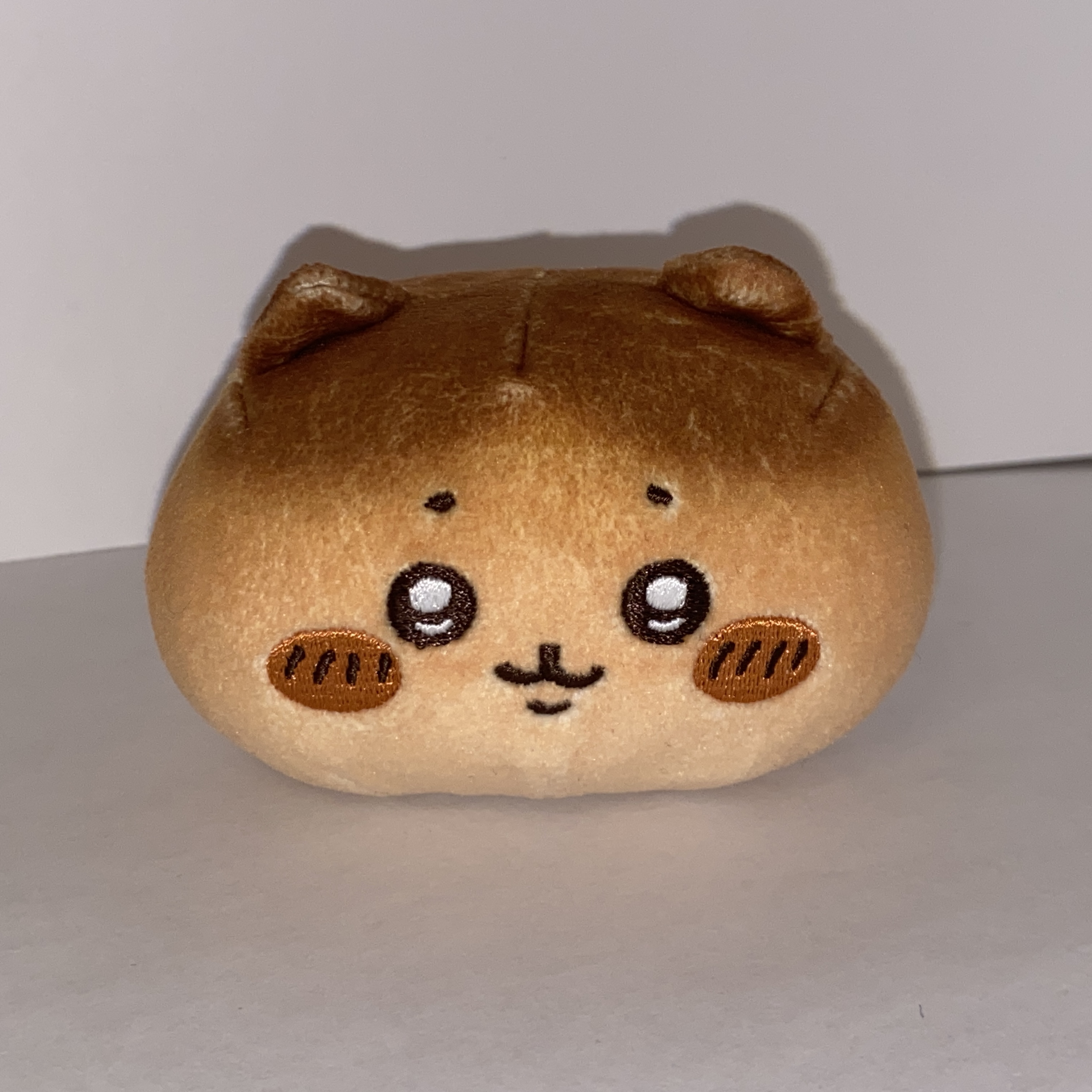 Image of a small round plushie.