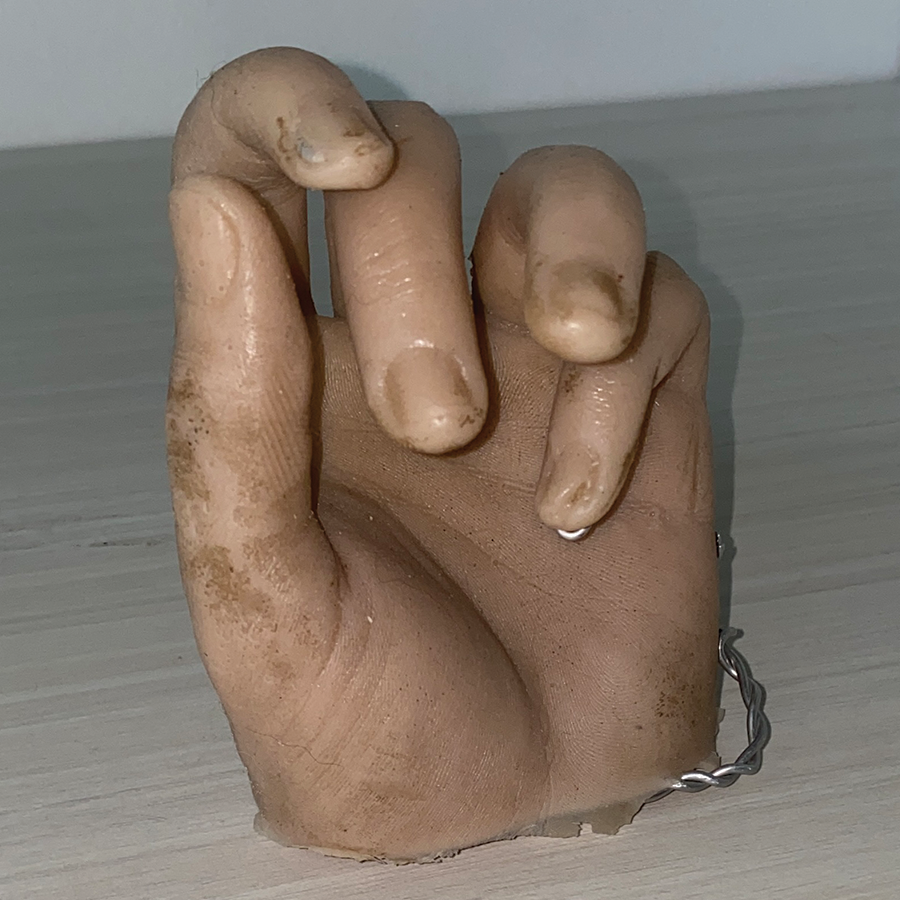 This is an image of a hand made out of silicone. Silicone is a pliable material in most cases, including this one. This has been refined as it has gone under a molding transformation. It is often used in prosthetics and special effects in movies because of its realistic texture and appearance.