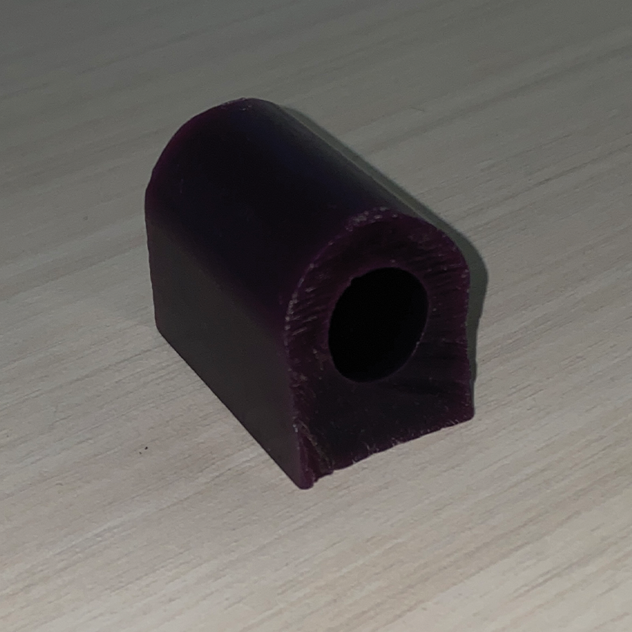 This is an image of jewellers wax. Jewellers wax is a type of wax used in the jewellery making process. It is a rigid material, often used to create models or prototypes of jewellery pieces before they are cast. It has been refined in order to maintain a ring-like shape.